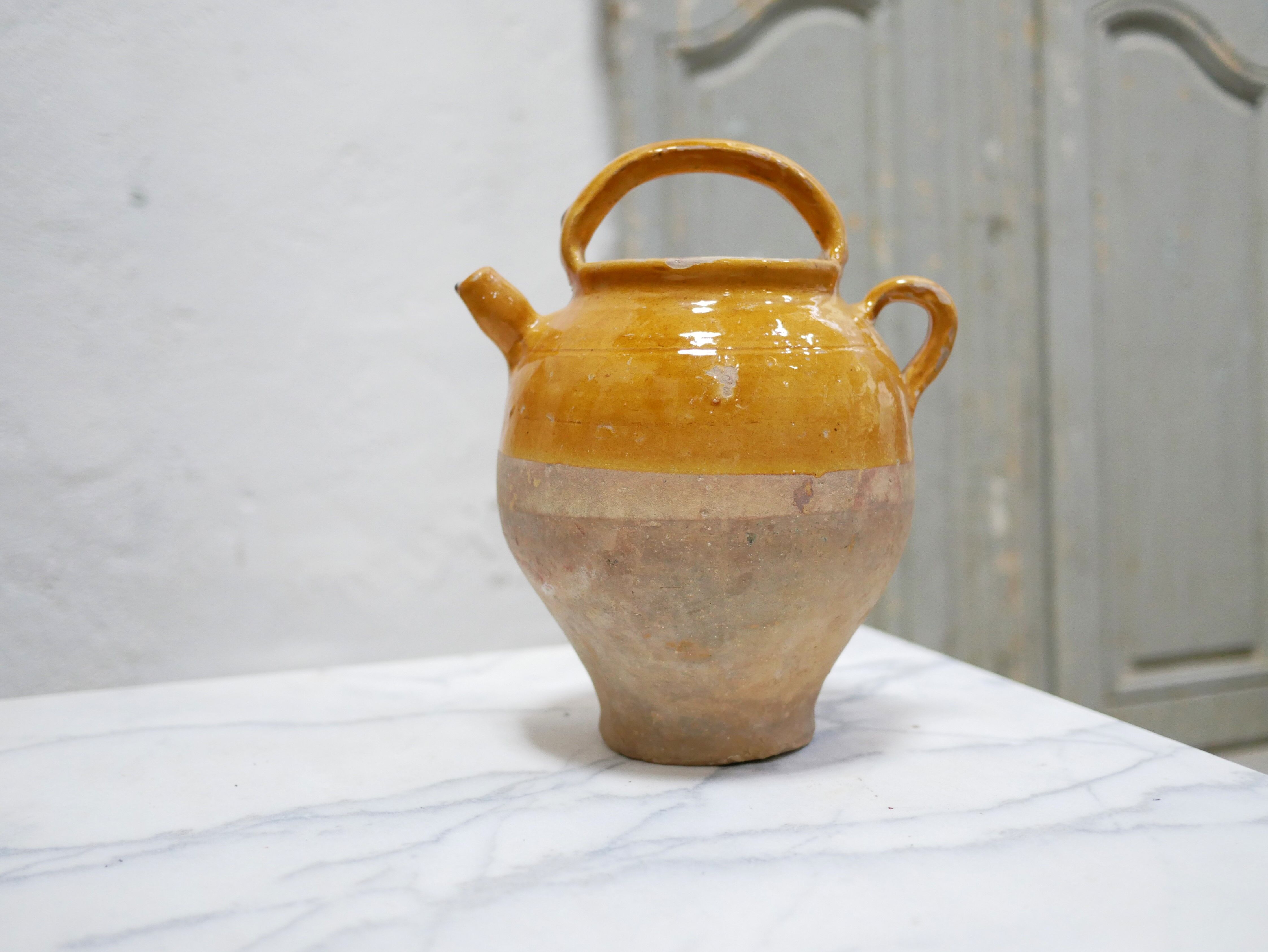 Old gargoulette pot in glazed terracotta