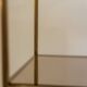 Free-standing shelf in gilded brass with smoked glass shelves. 1970s.