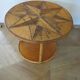 Round coffee table in bamboo, rattan, and wood with an 80s star pattern.