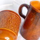 Duo of French-English brown and terracotta cups