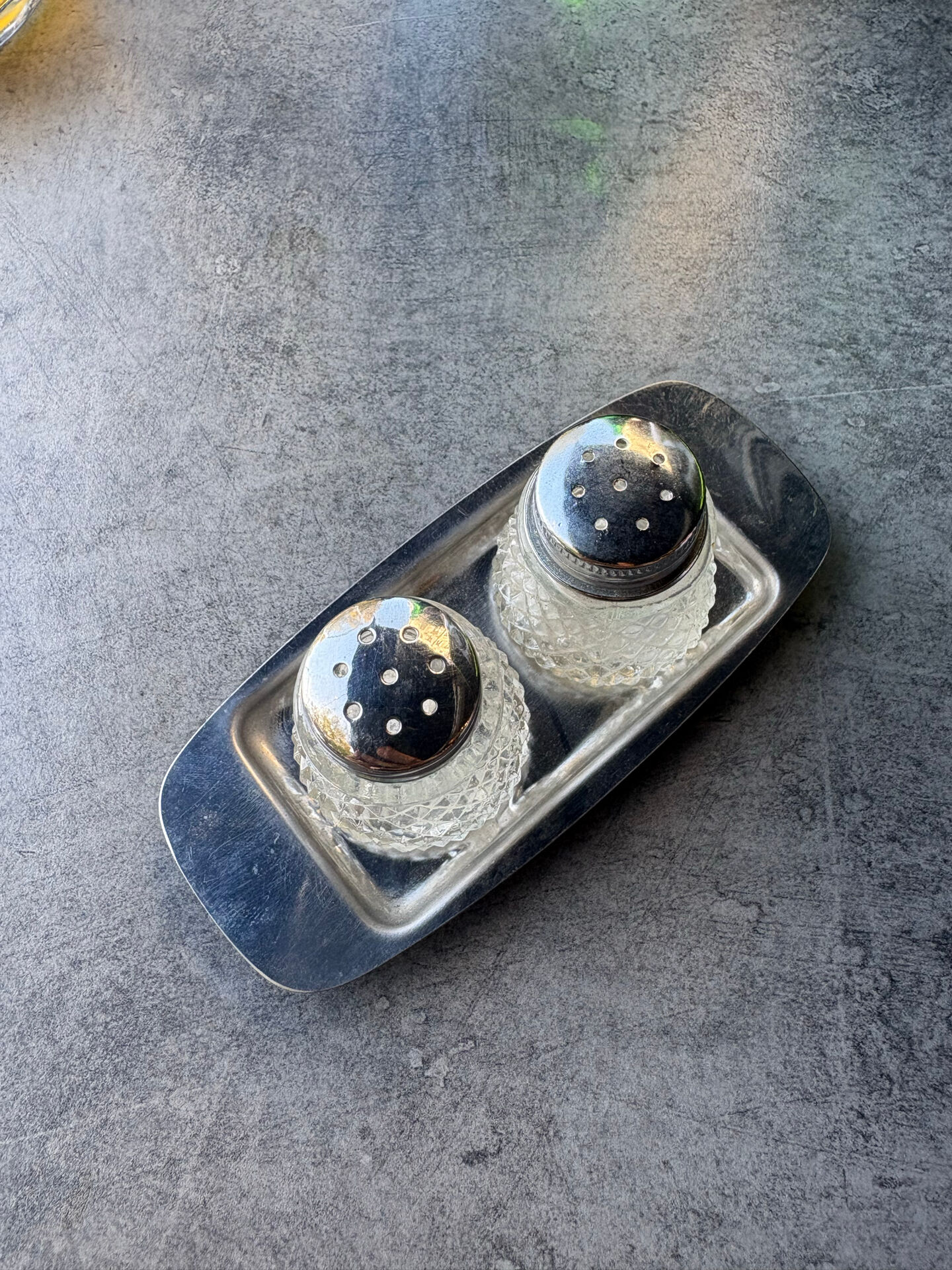 Vintage glass and chrome salt and pepper shaker set.