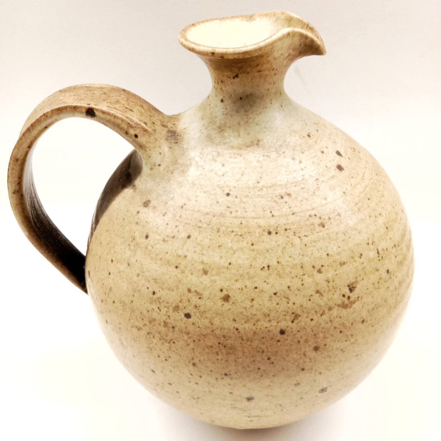 Vintage speckled brown stoneware jug in a round shape.