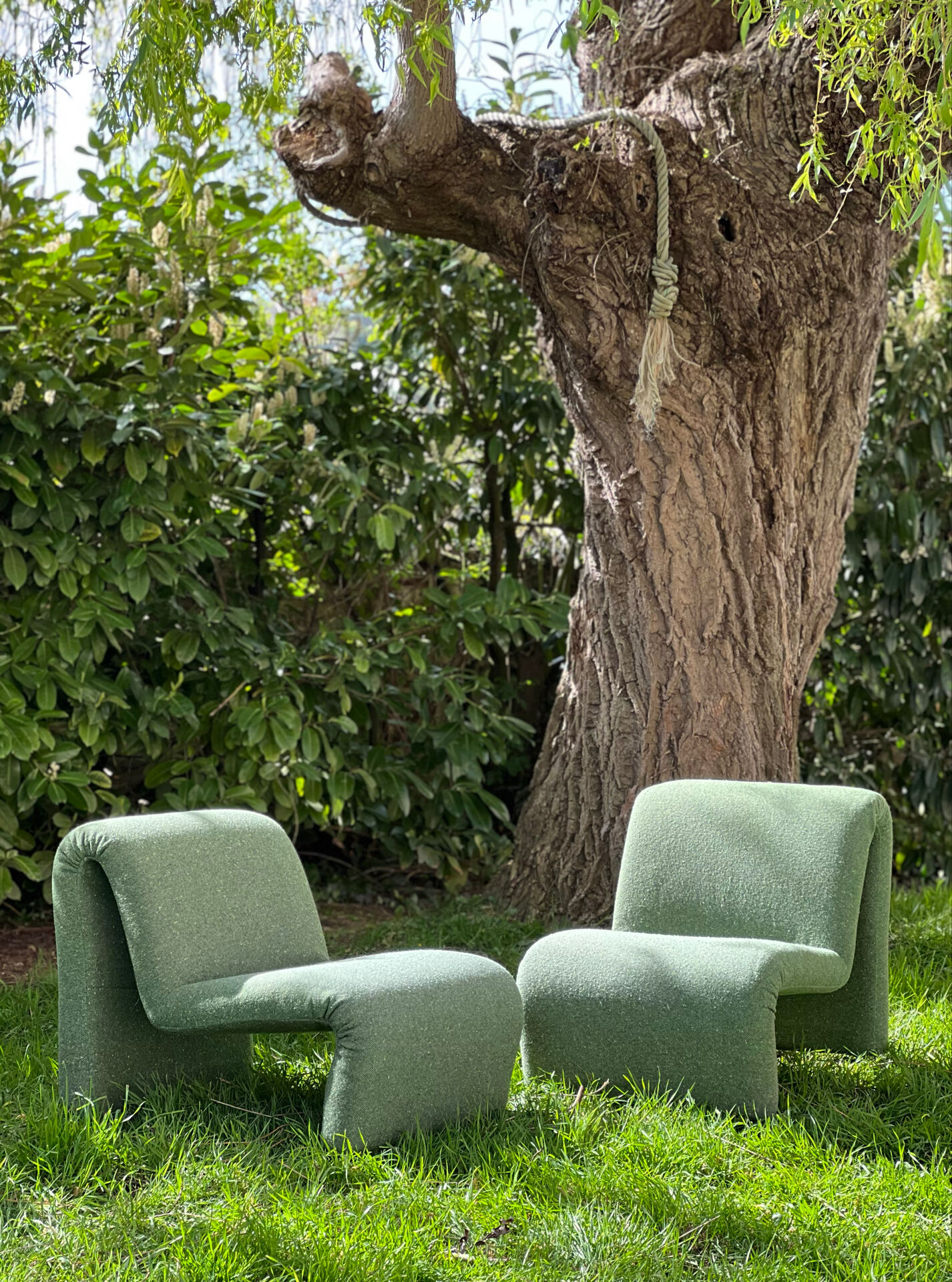 Green armchairs designed by Étienne Fermigier