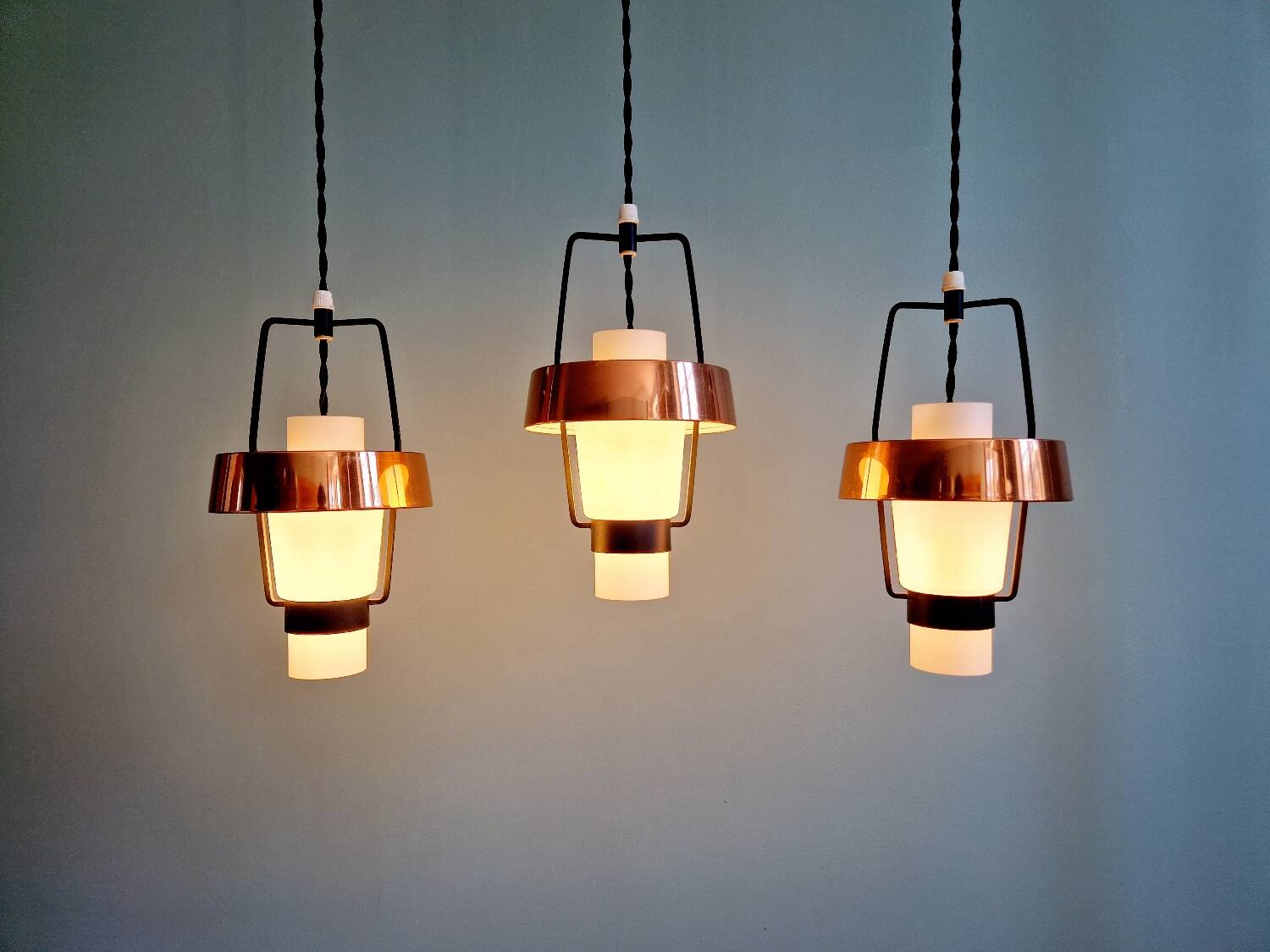Trio of Scandinavian pendant lights in opaline and copper metal, 1960s