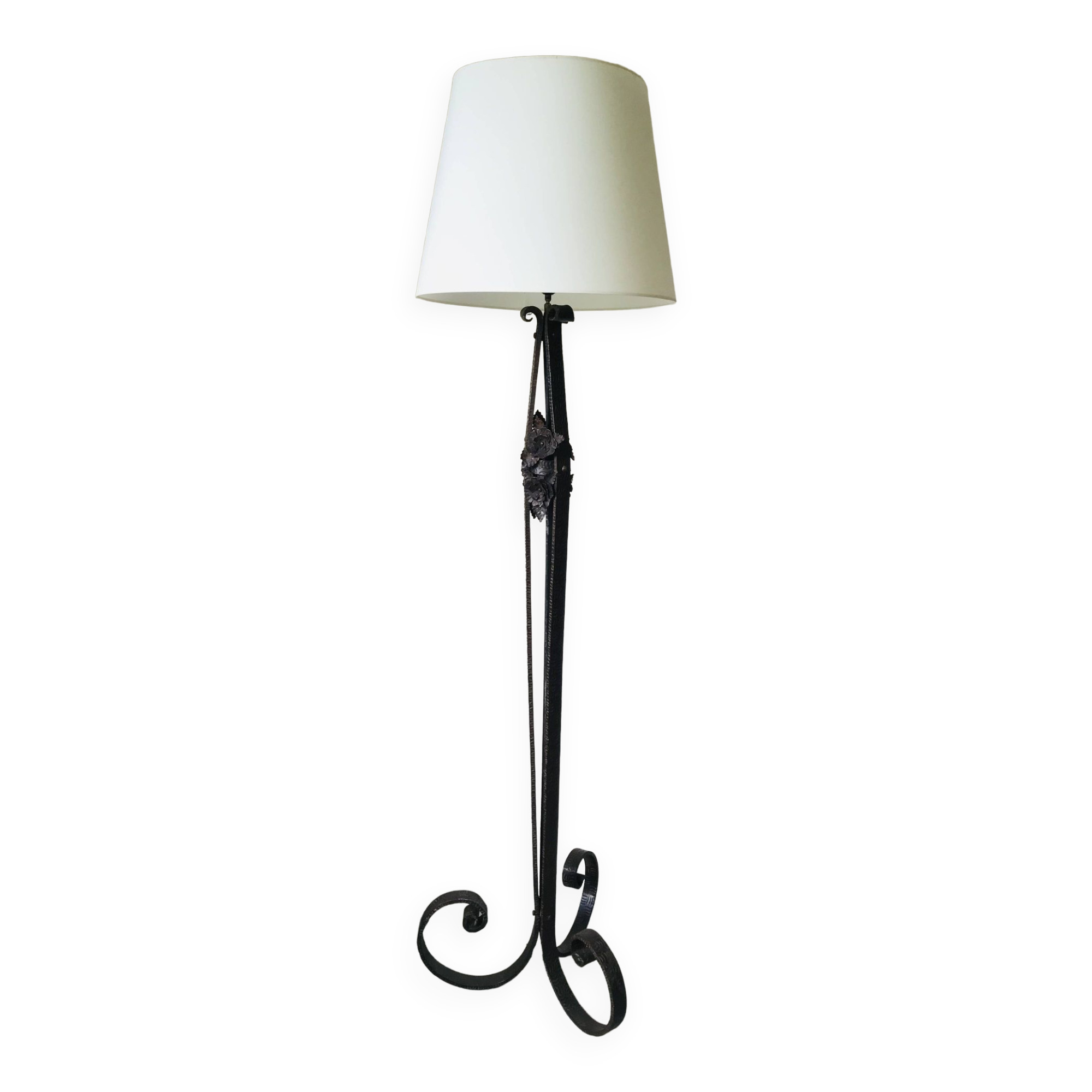 Art deco wrought iron floor lamp decorated with flowers, circa 1930.