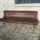 Public bench in wooden slats and cast iron legs