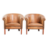 Set of two vintage sheepskin club armchairs with a beautiful light colour