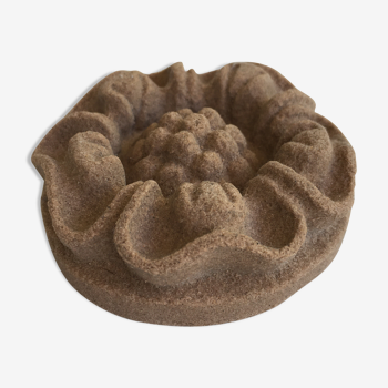 Pink sandstone paperweight in the shape of a rosette