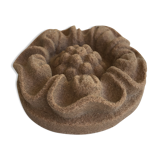 Pink sandstone paperweight in the shape of a rosette