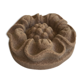 Pink sandstone paperweight in the shape of a rosette