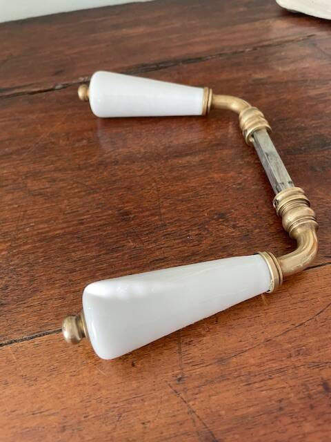 pair of porcelain handle levers with brass rods, antique