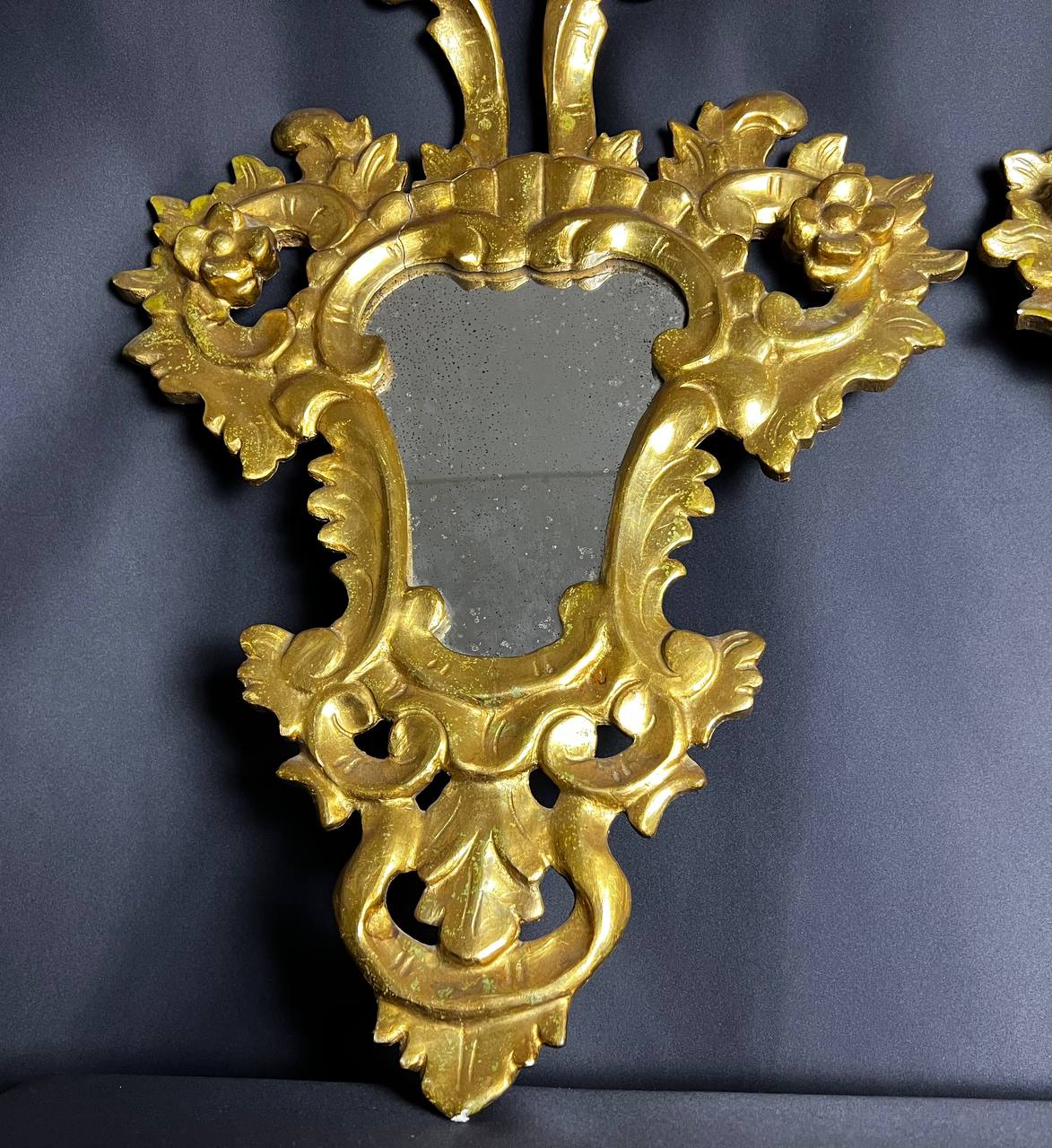 Pair of carved and gilded wooden mirrors, Italian Baroque style, 19th century.