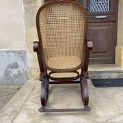 Curved wooden rocking chair with caning