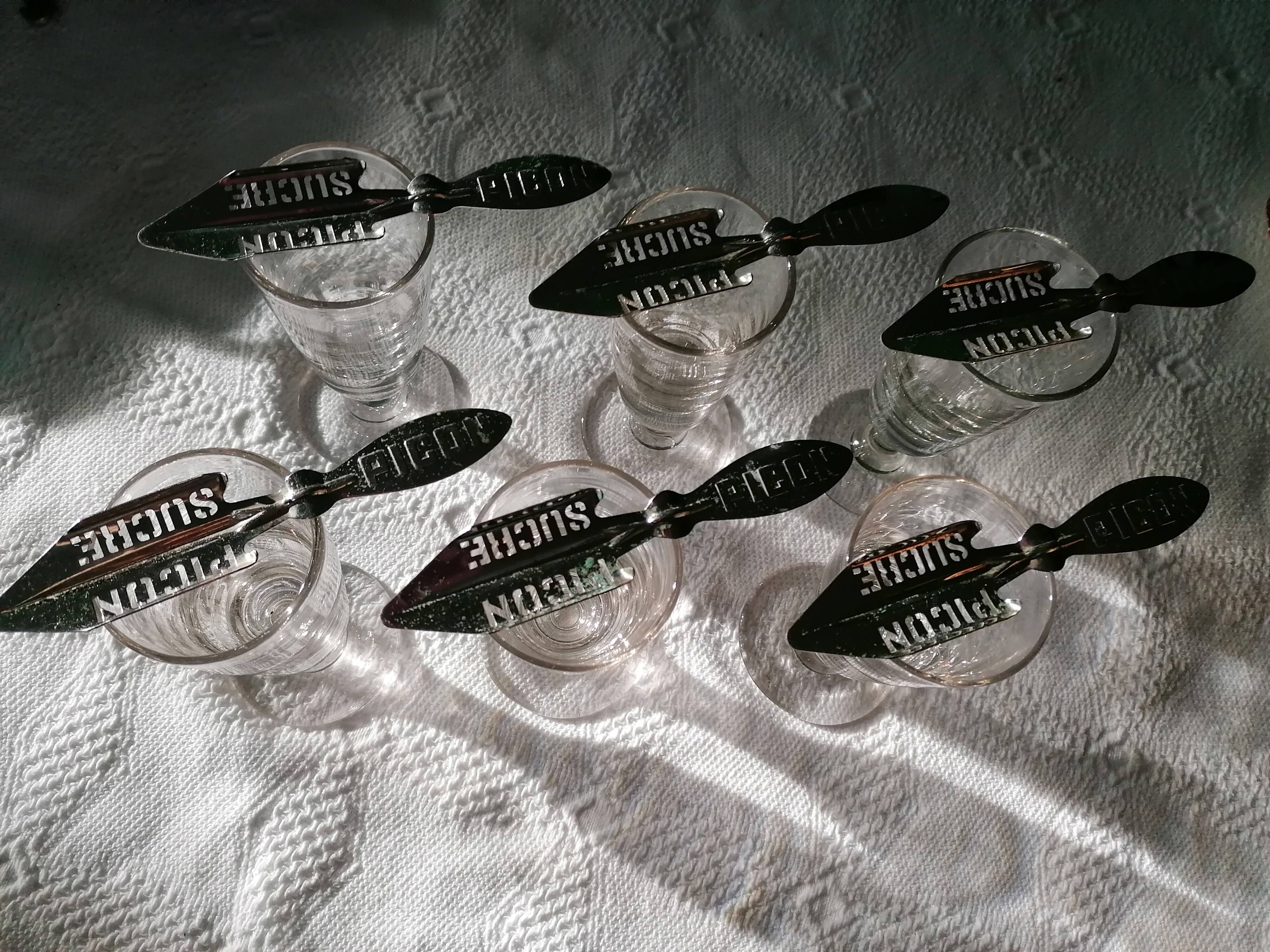 Absinthe service glasses and spoons.
