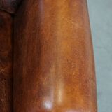 Cognac-colored vintage sheep leather wingback chair with character