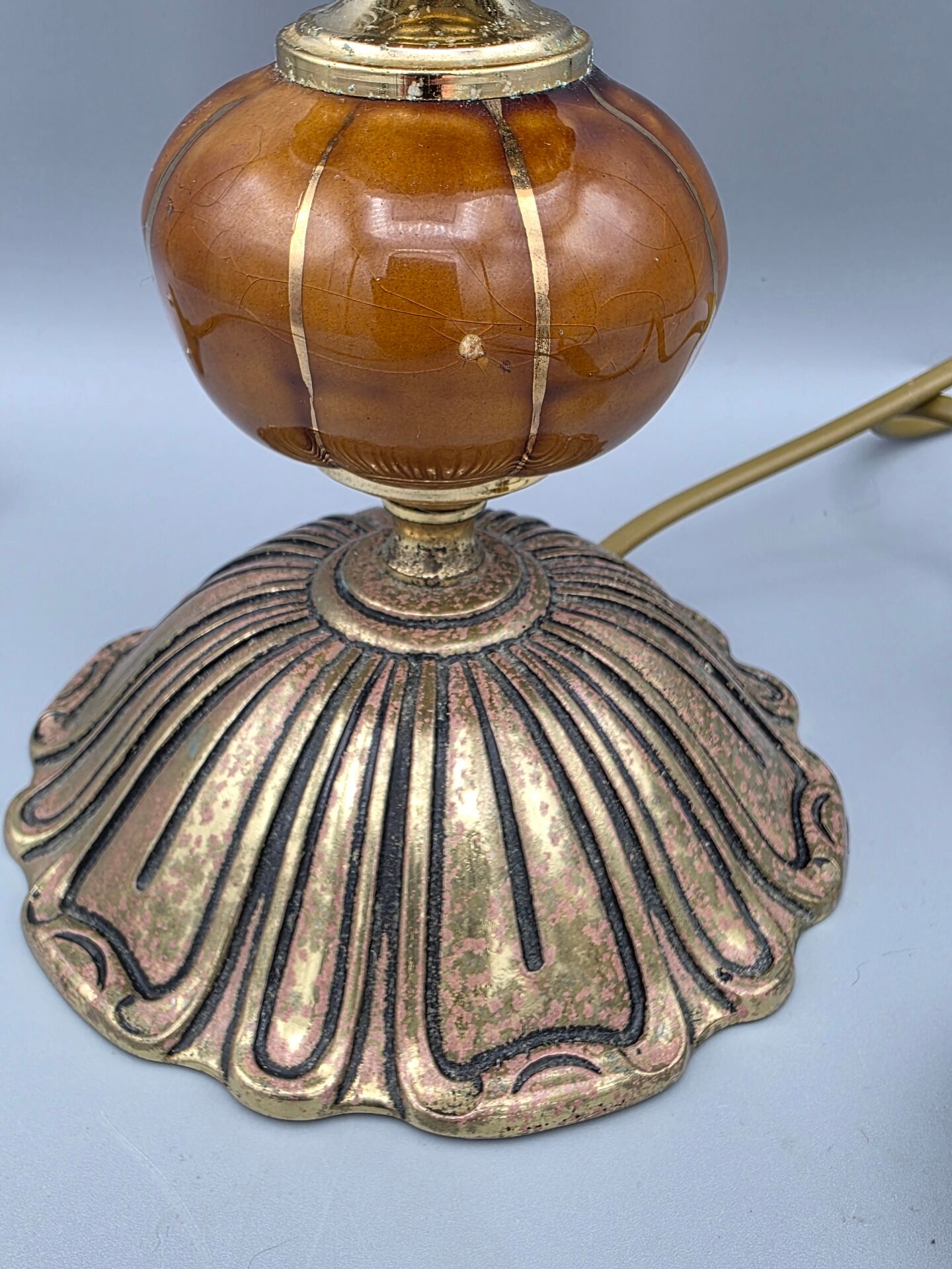 Hollywood Regency bedside lamp in gold metal with a glass globe.