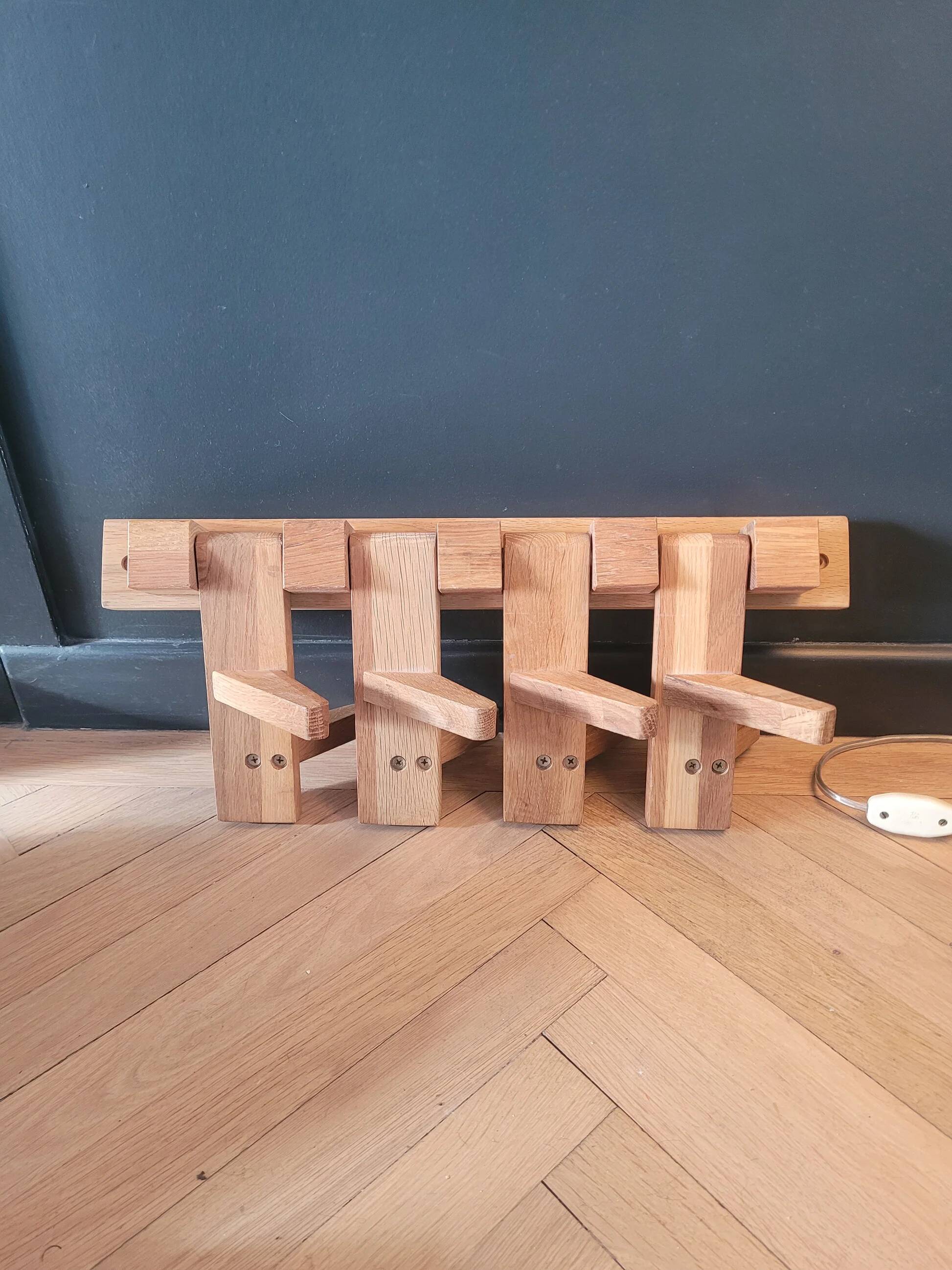 Articulated vertical wall coat rack