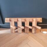 Articulated vertical wall coat rack