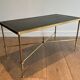 Neoclassical brass coffee table with a black leather top and golden borders from Maison Jansen.