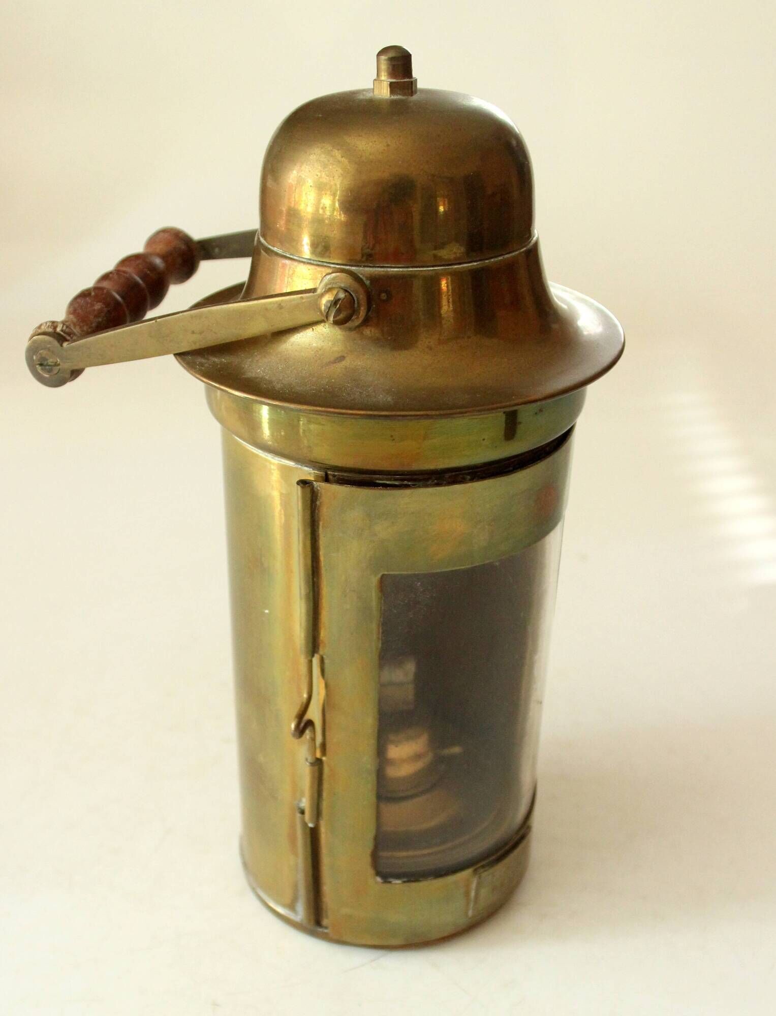 Decorative brass and glass oil lamp, wind light with wooden handle, vintage from the 1970s