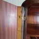 Vintage 1960s wooden wardrobe with a central mirror and tapered legs.