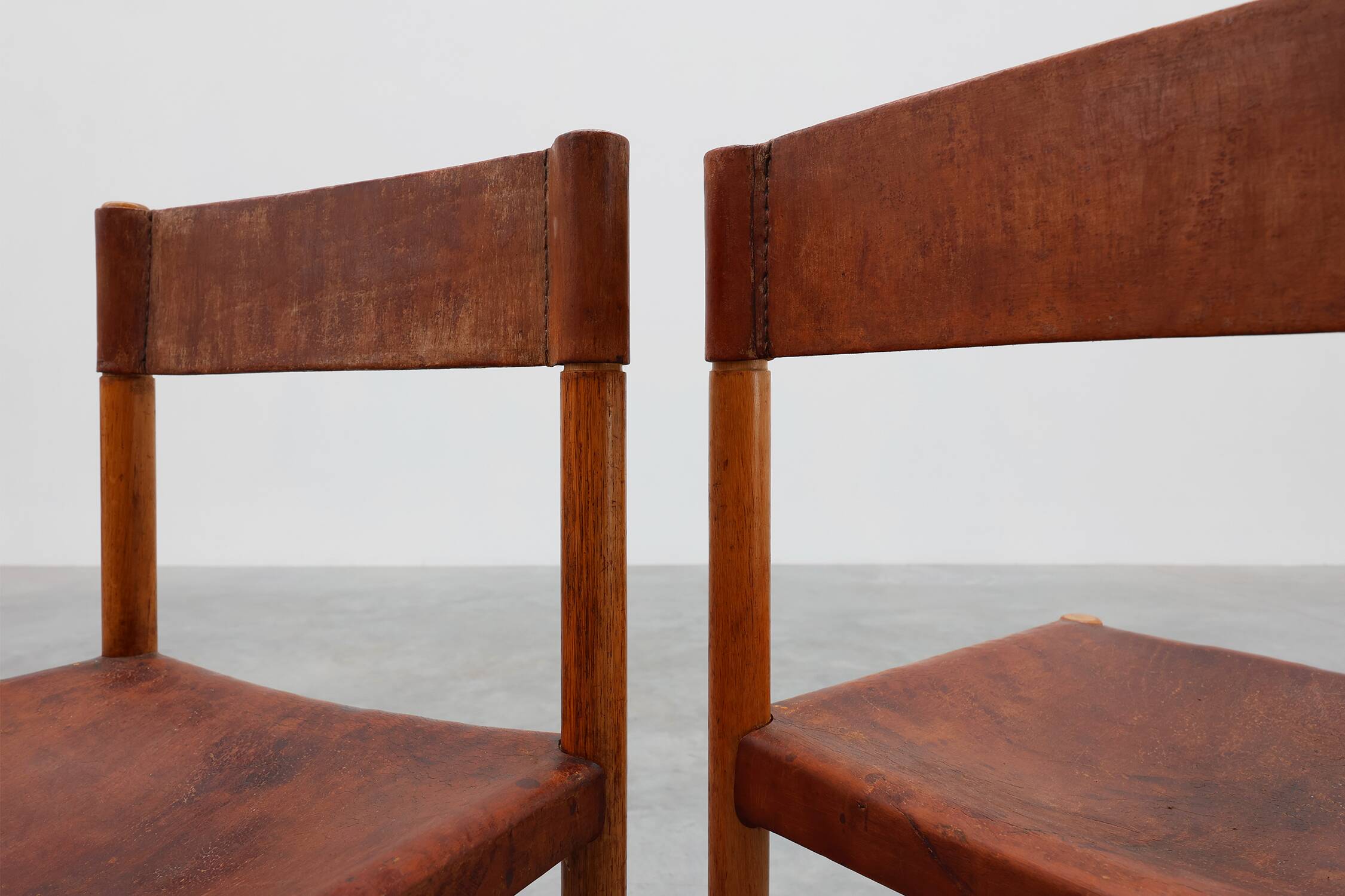 Pair of wood and leather Spanish chairs by Jordi Vilanova, ca. 1960