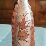 Small clay vase decorated with leaves
