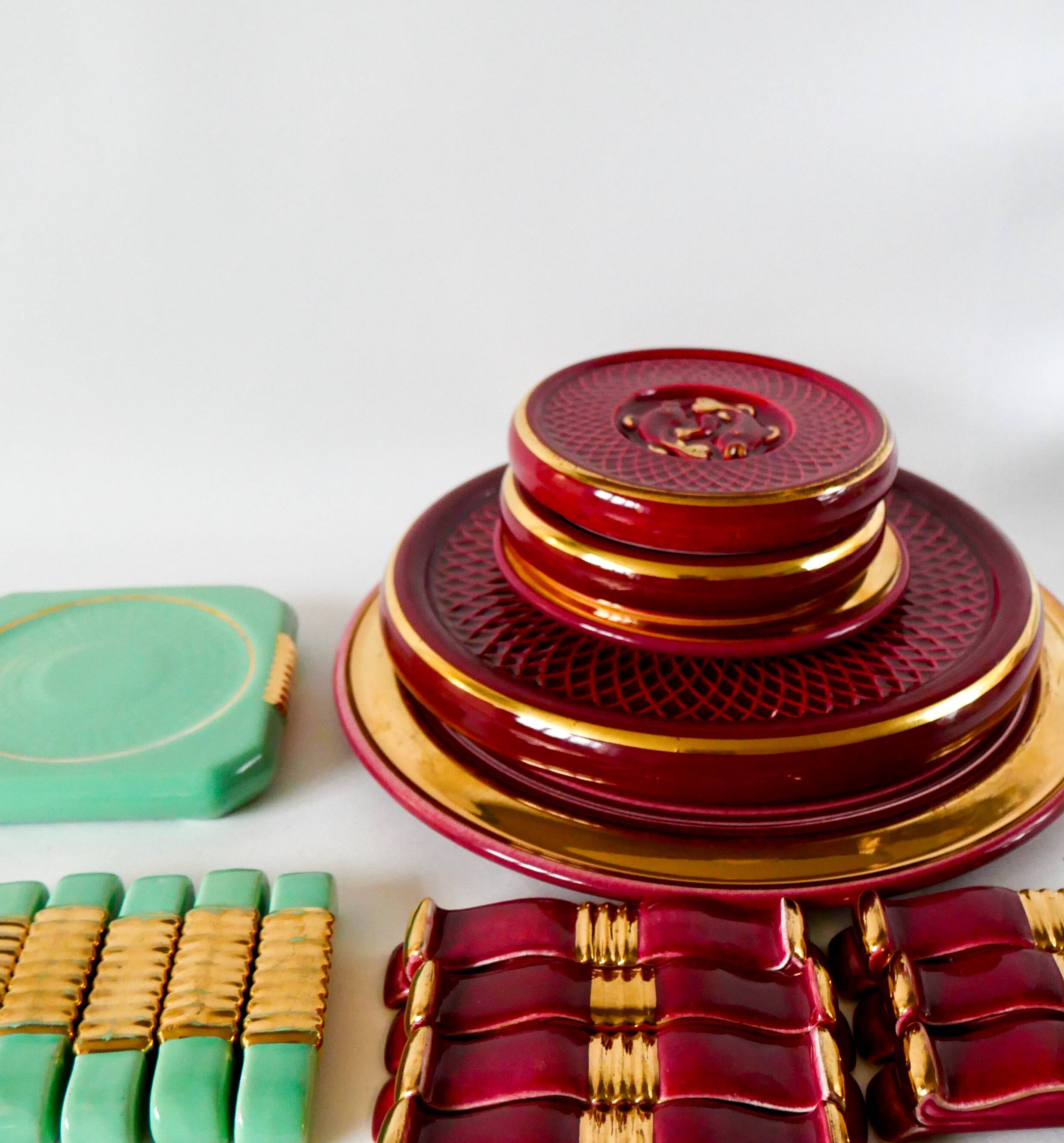 set of trivets, bottle coasters and knife holders in art de cherry-colored ceramic