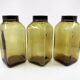 3 molded amber glass pharmacy bottles • Bakelite stoppers • 1950