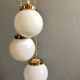 Three-light cascade suspension, vintage globes in white opaline