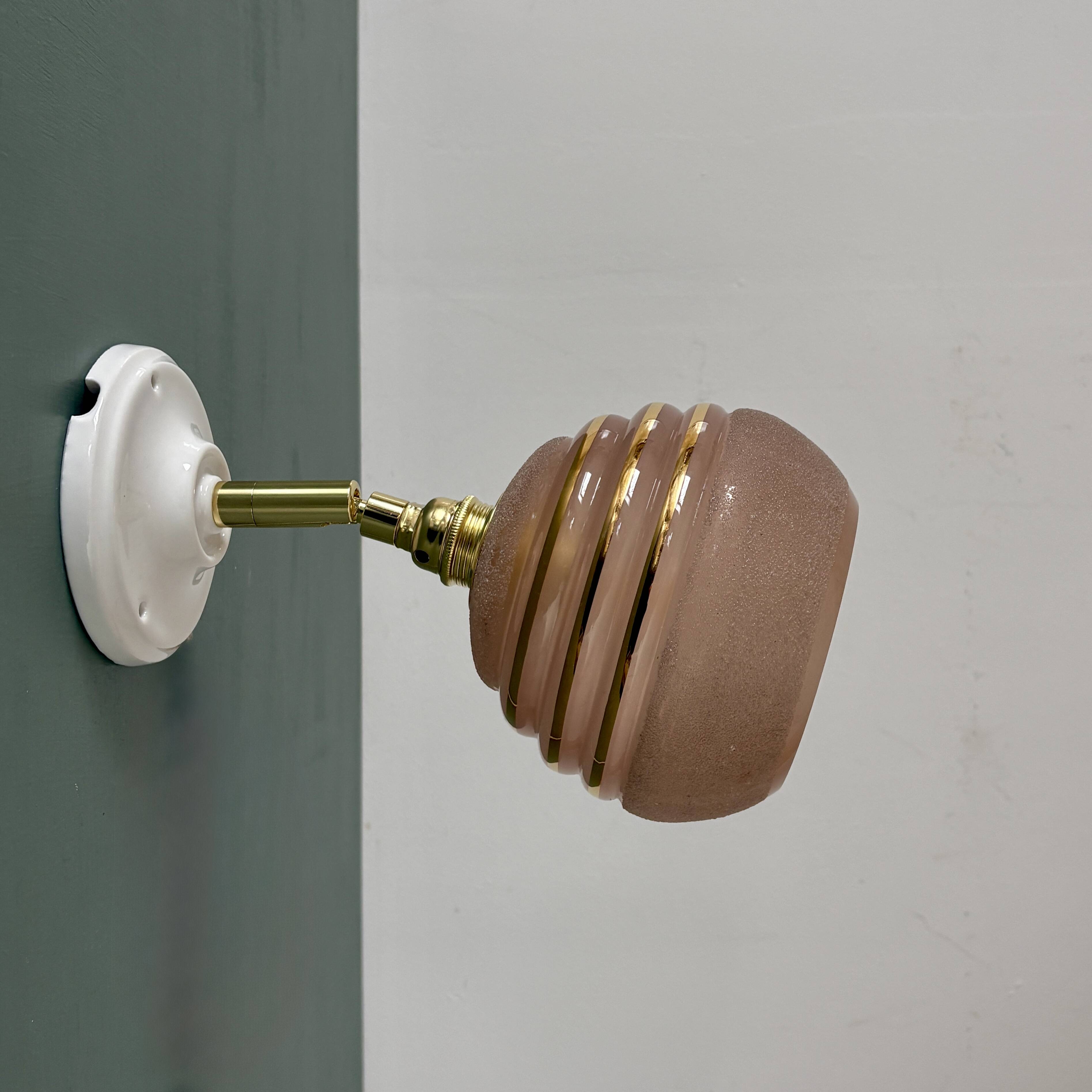 Vintage globe wall light in frosted pink and gold glass.