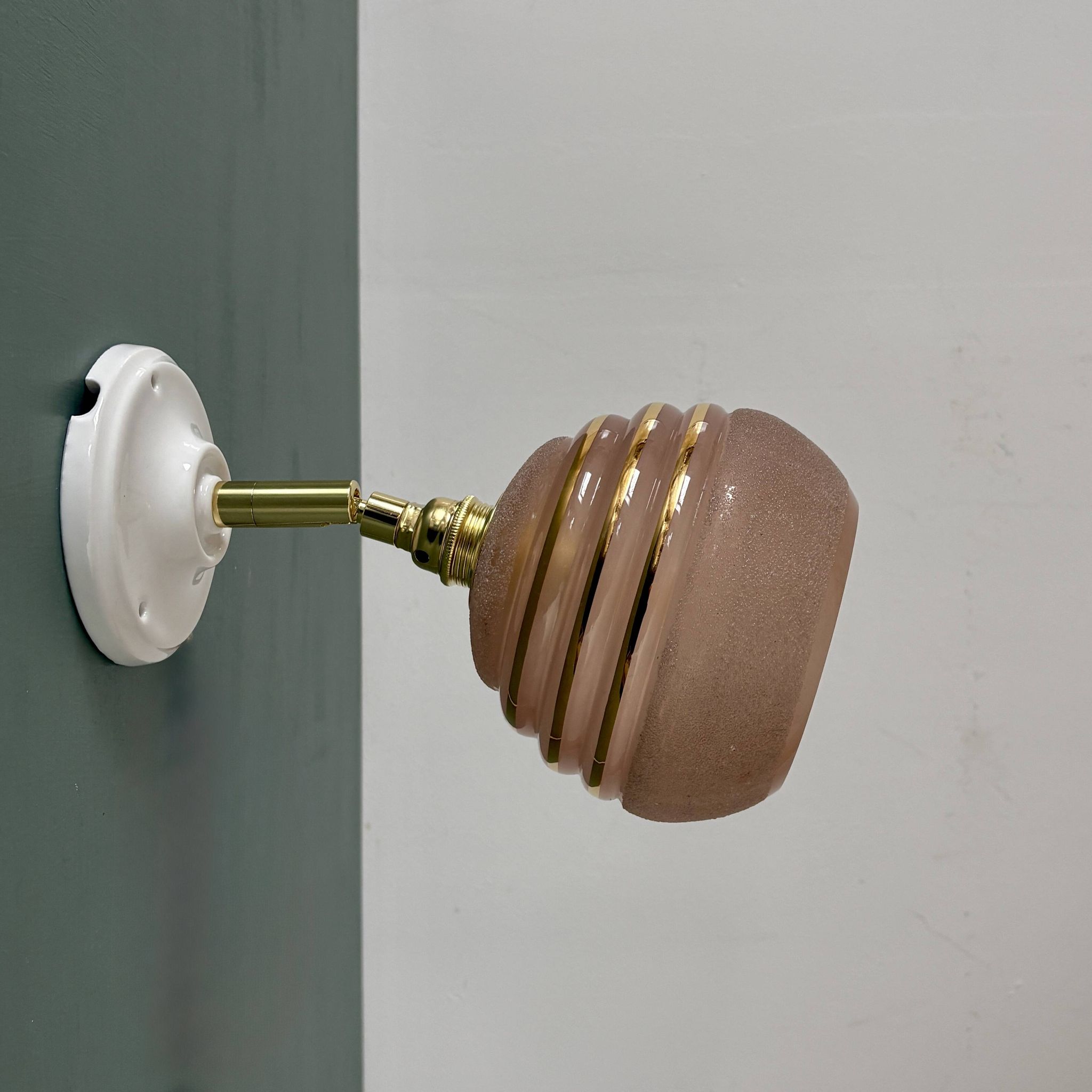 Vintage globe wall light in frosted pink and gold glass.