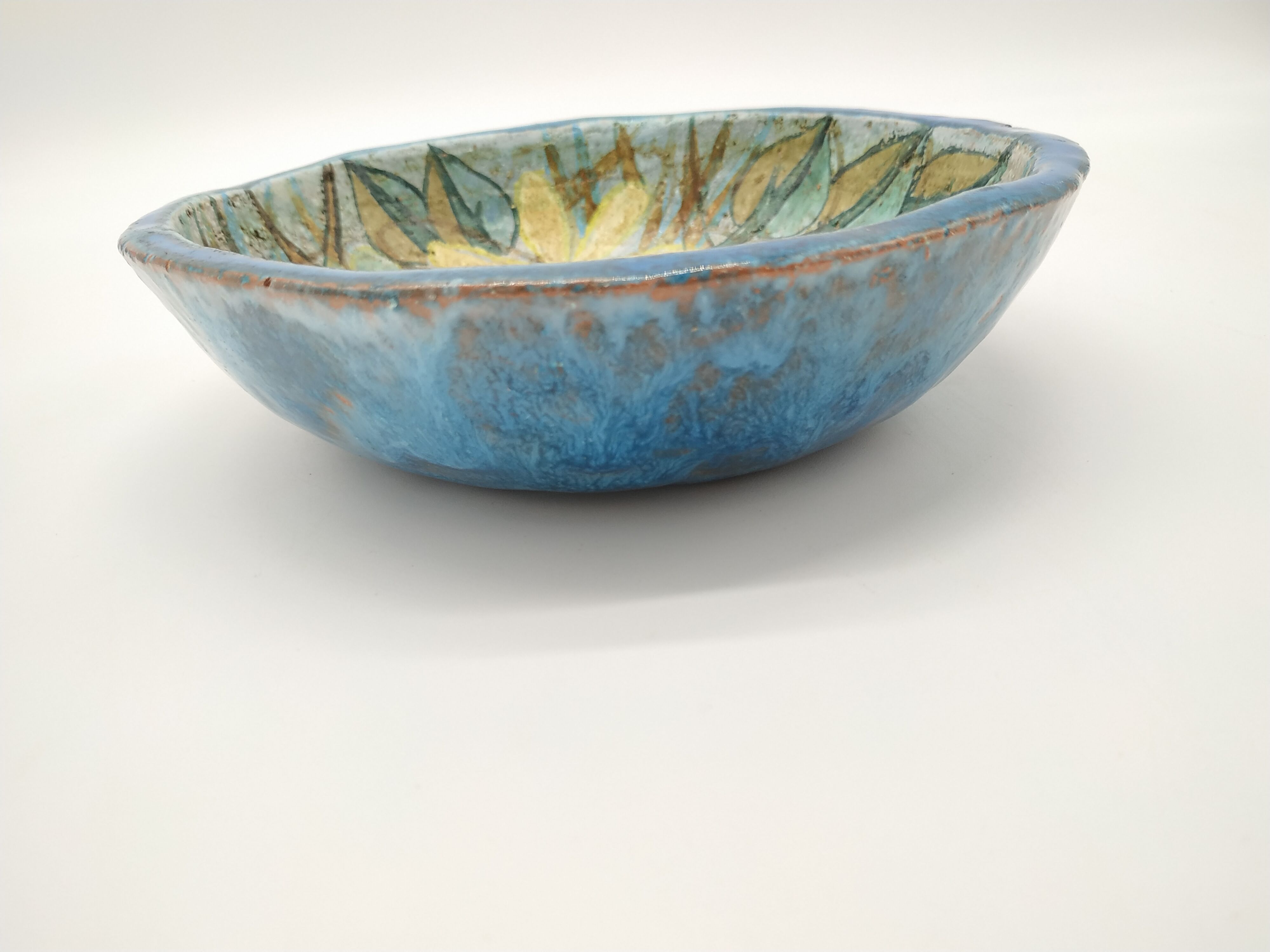 Hollow cut in blue enamelled sandstone decorated with yellow flowers