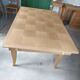Oak dining table with a checkerboard top and extensions.
