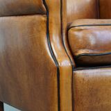 Ensemble de 2 fauteuils en cuir de mouton avec finition passepoil noir