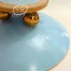 Art Deco modernist coupe, with a base of 3 spheres, in turquoise ceramic and gilding.