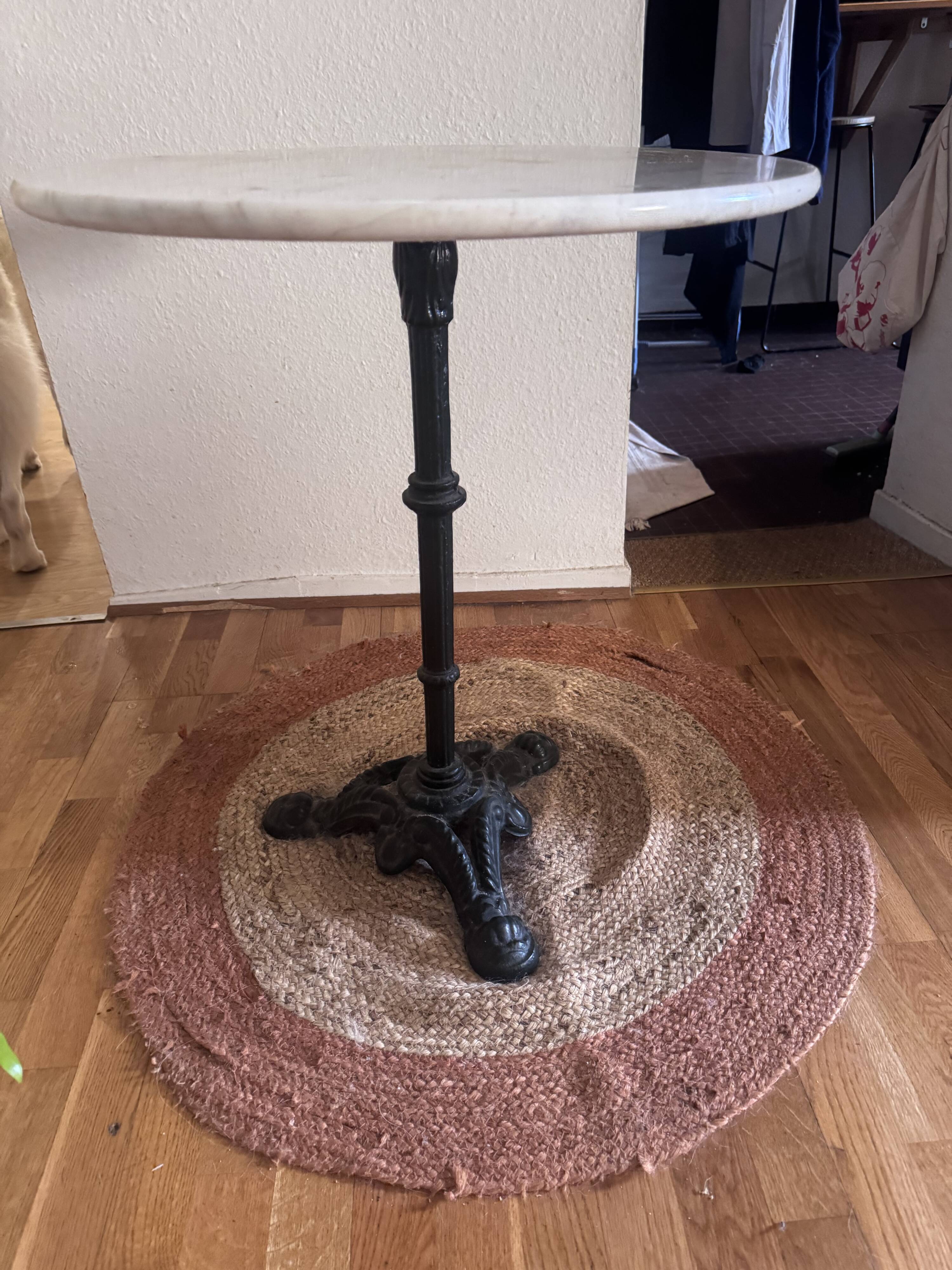 Marble side table with a cast iron base.