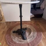 Marble side table with a cast iron base.