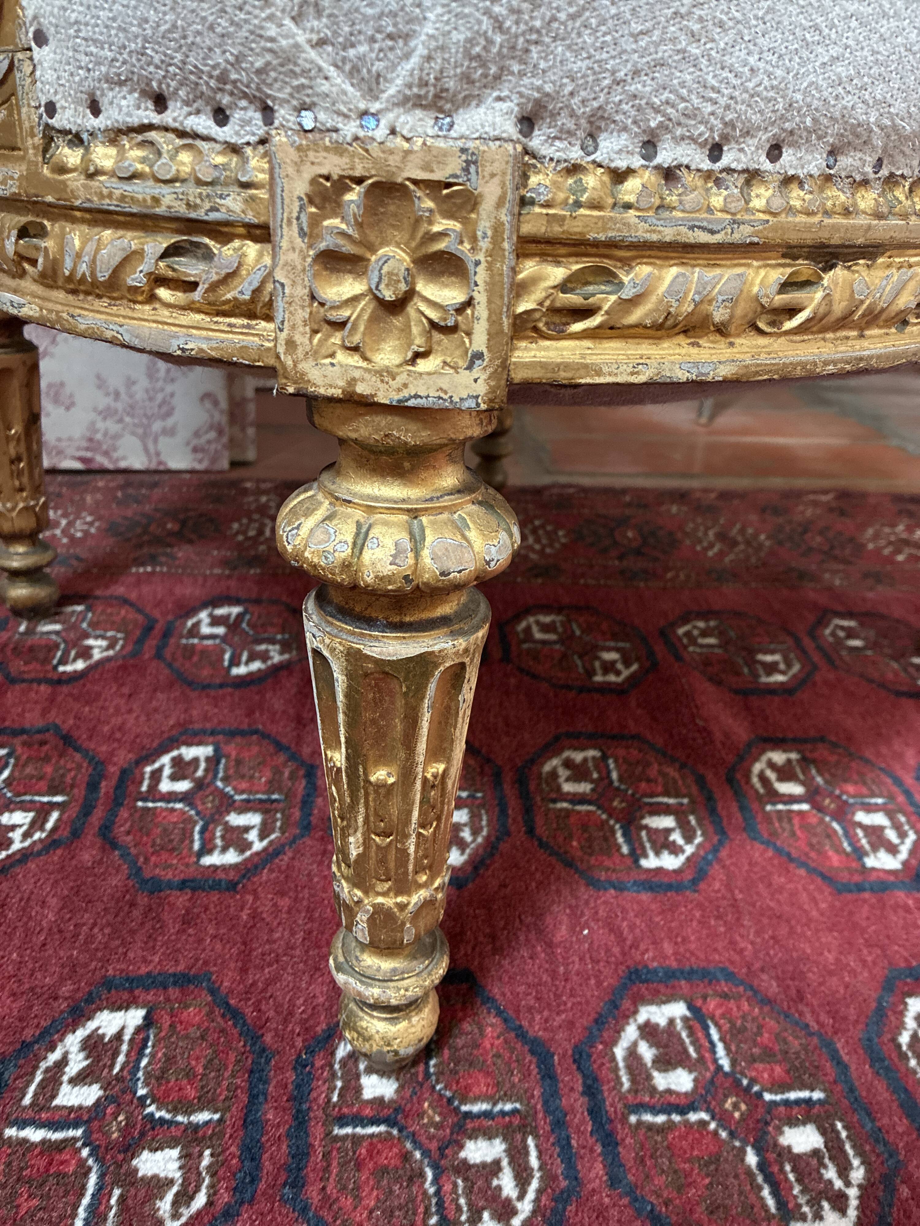 Large cabriolet armchair in Louis XVI style with gilded wood.