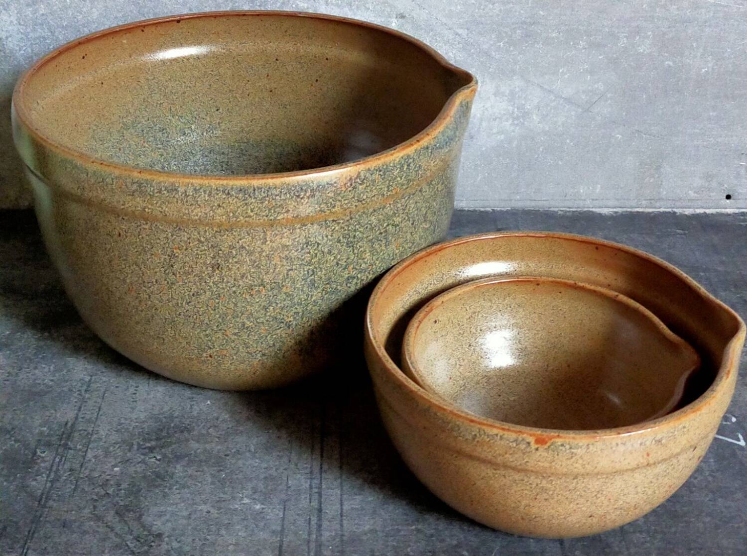 Three nesting pottery salad bowls in glazed stoneware