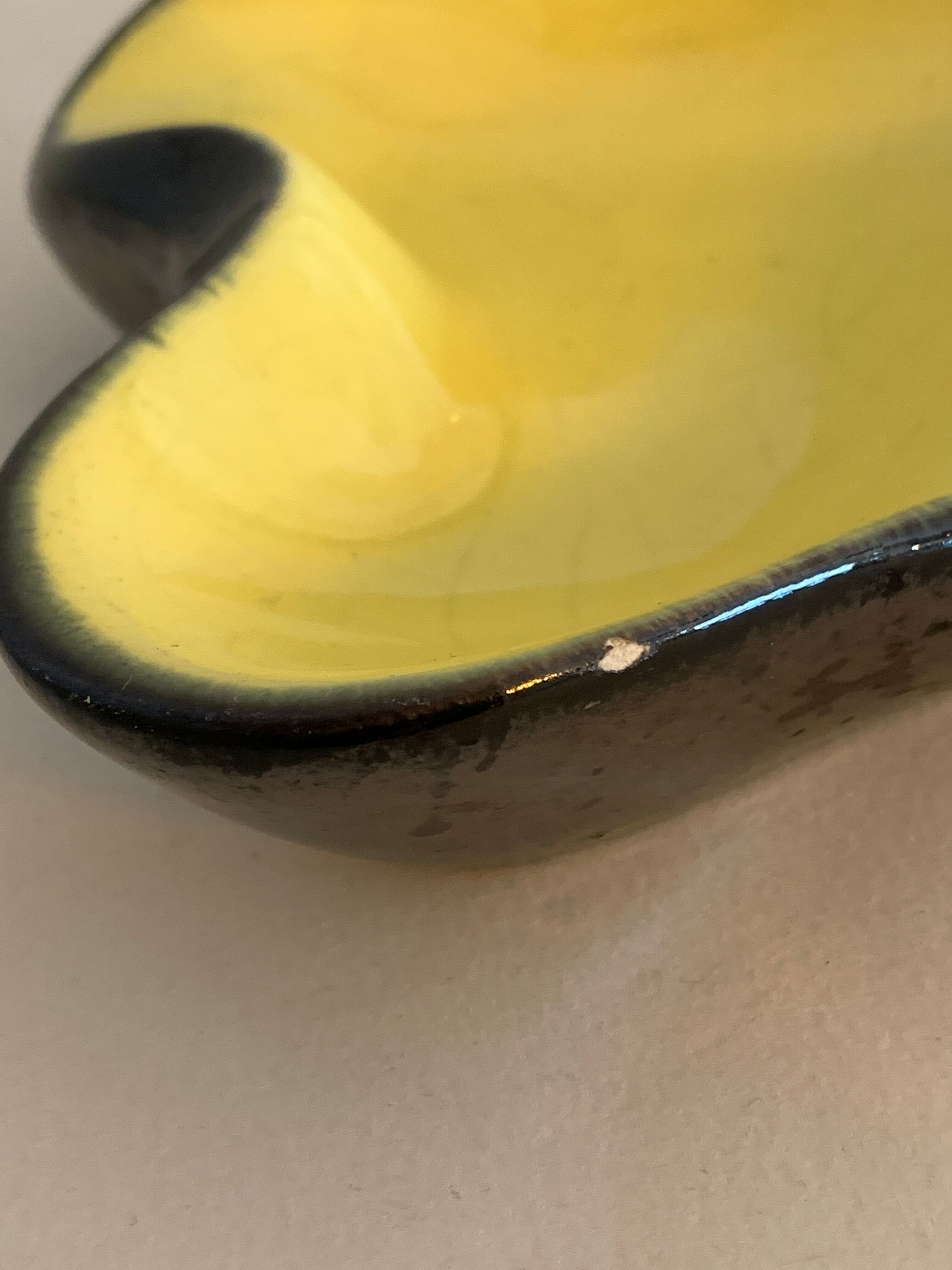 Yellow and black ceramic ashtray