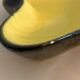 Yellow and black ceramic ashtray