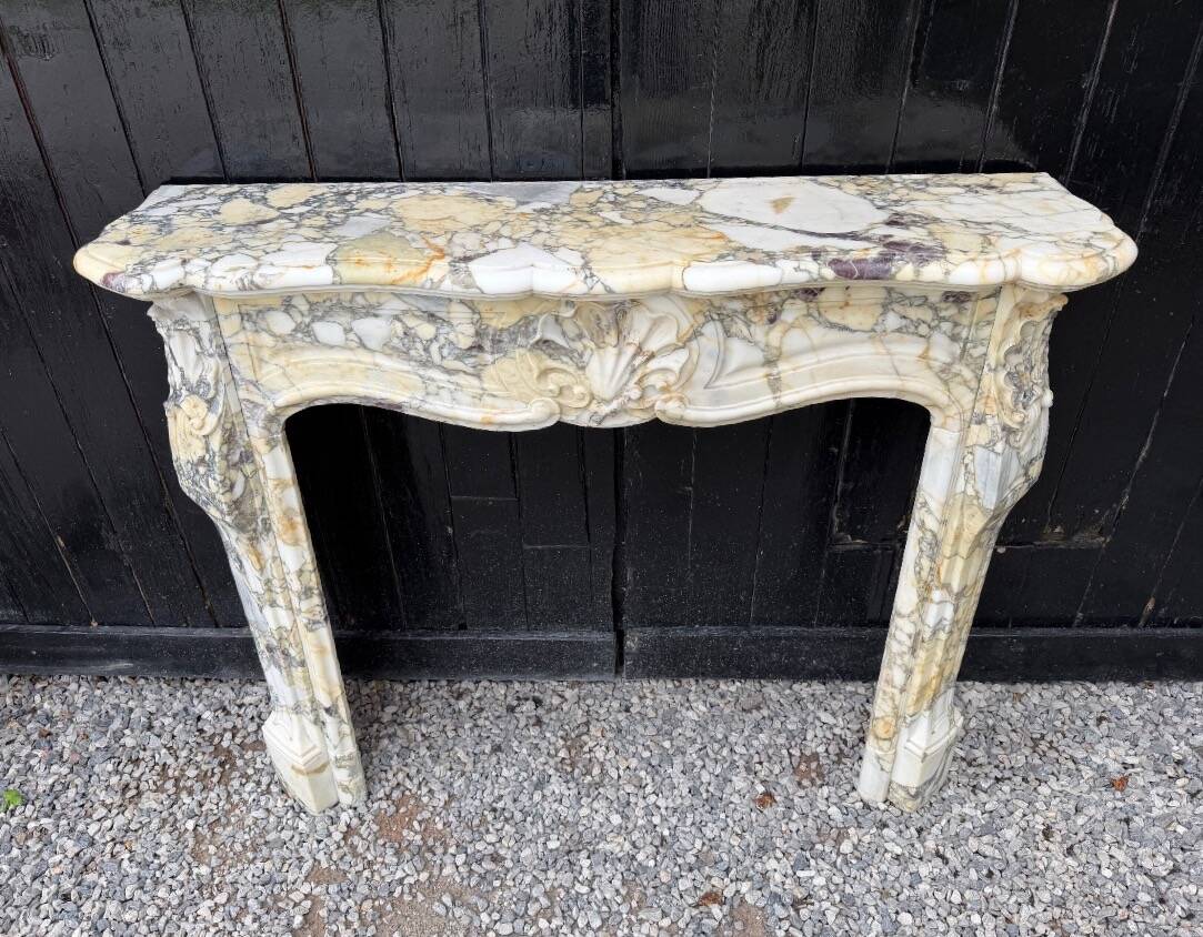 Louis XV style fireplace in purple breccia marble, circa 1880.