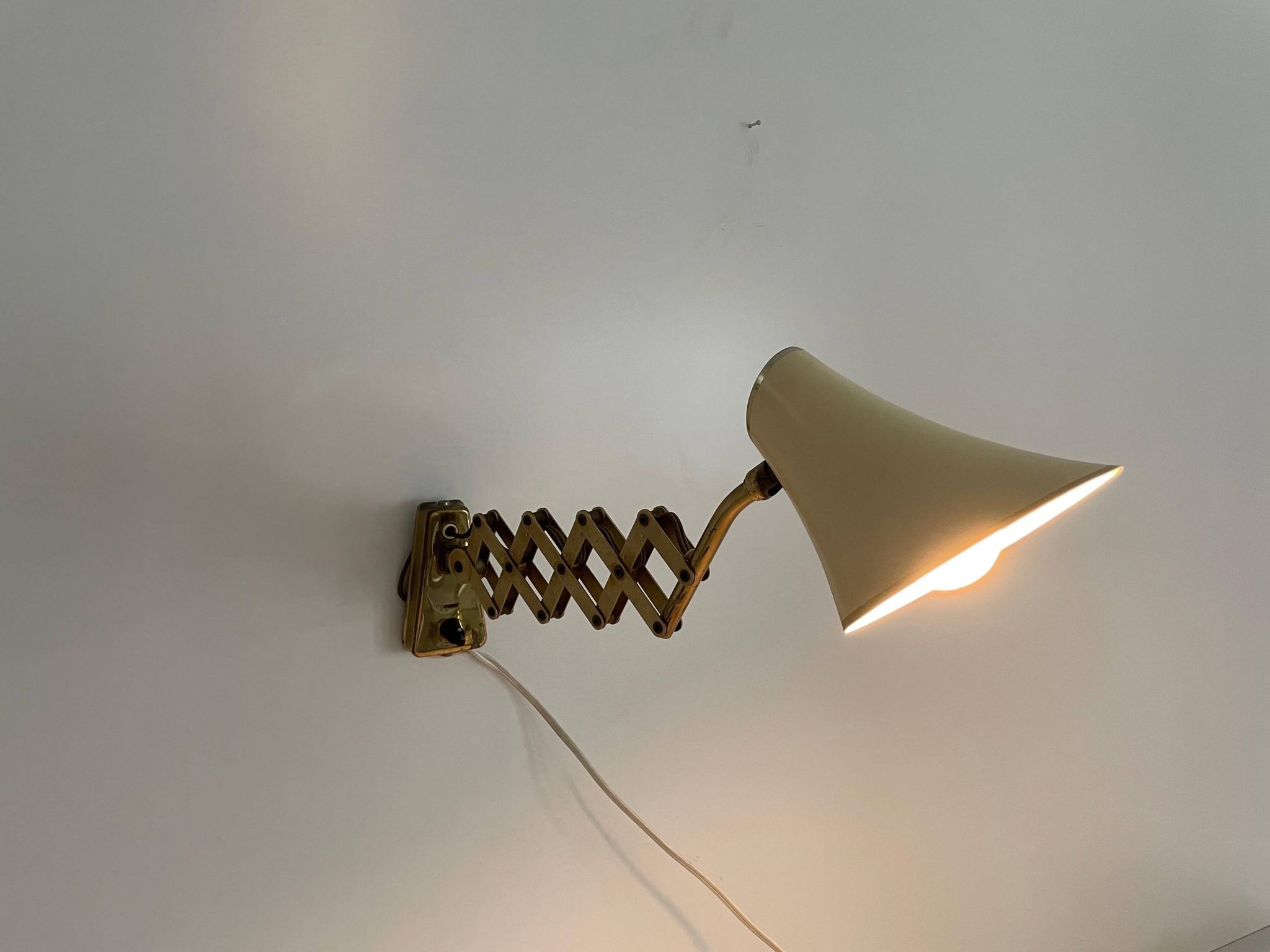 Cream metal and brass wall lamp with scissors design by Karl Lang for SIS Licht, 1950s, Germany.