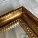 Bronze-colored framed mirror