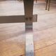 Table basse en acier brossé et verre fumé