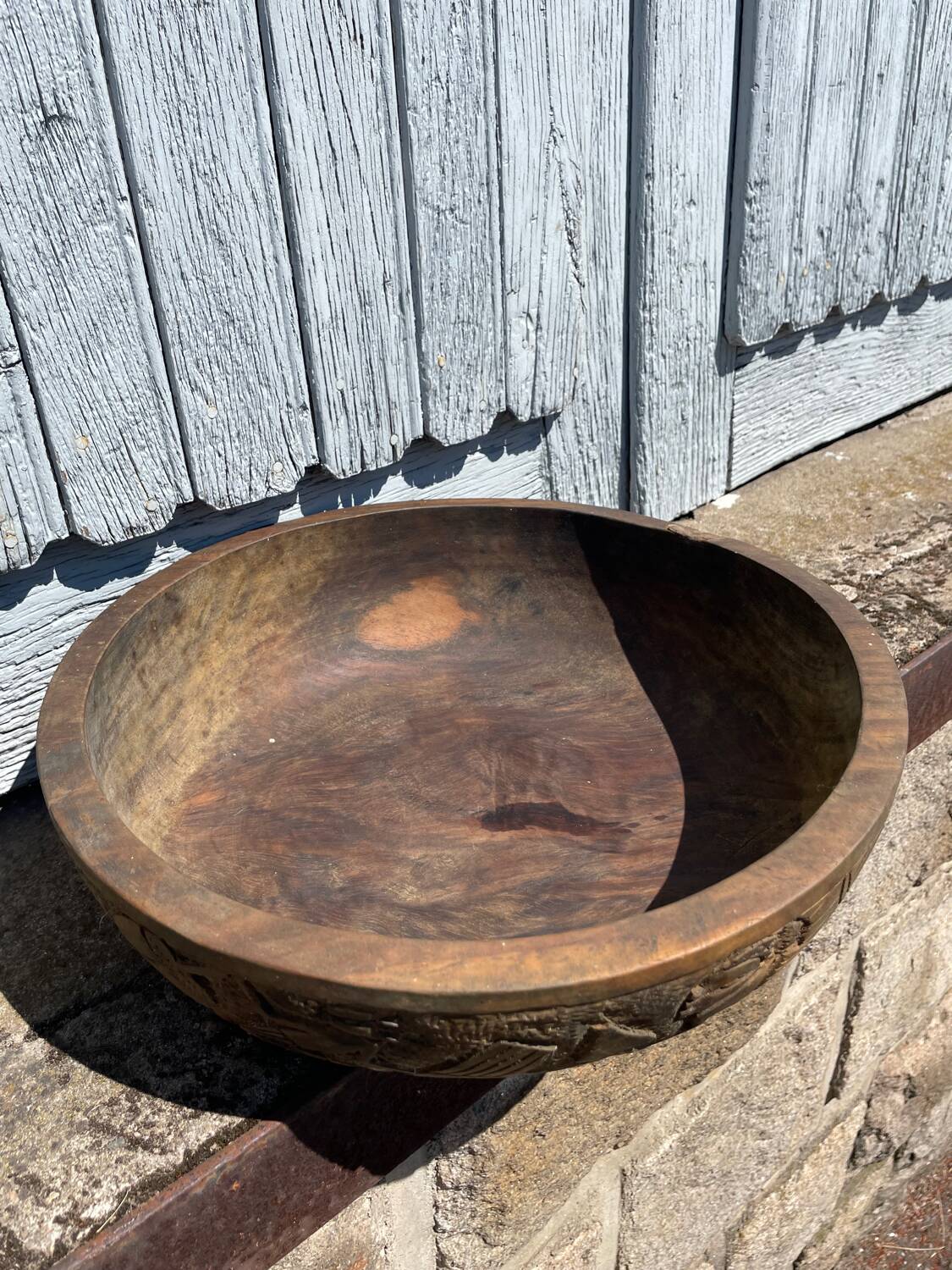 Old carved wooden bowl with African decoration.