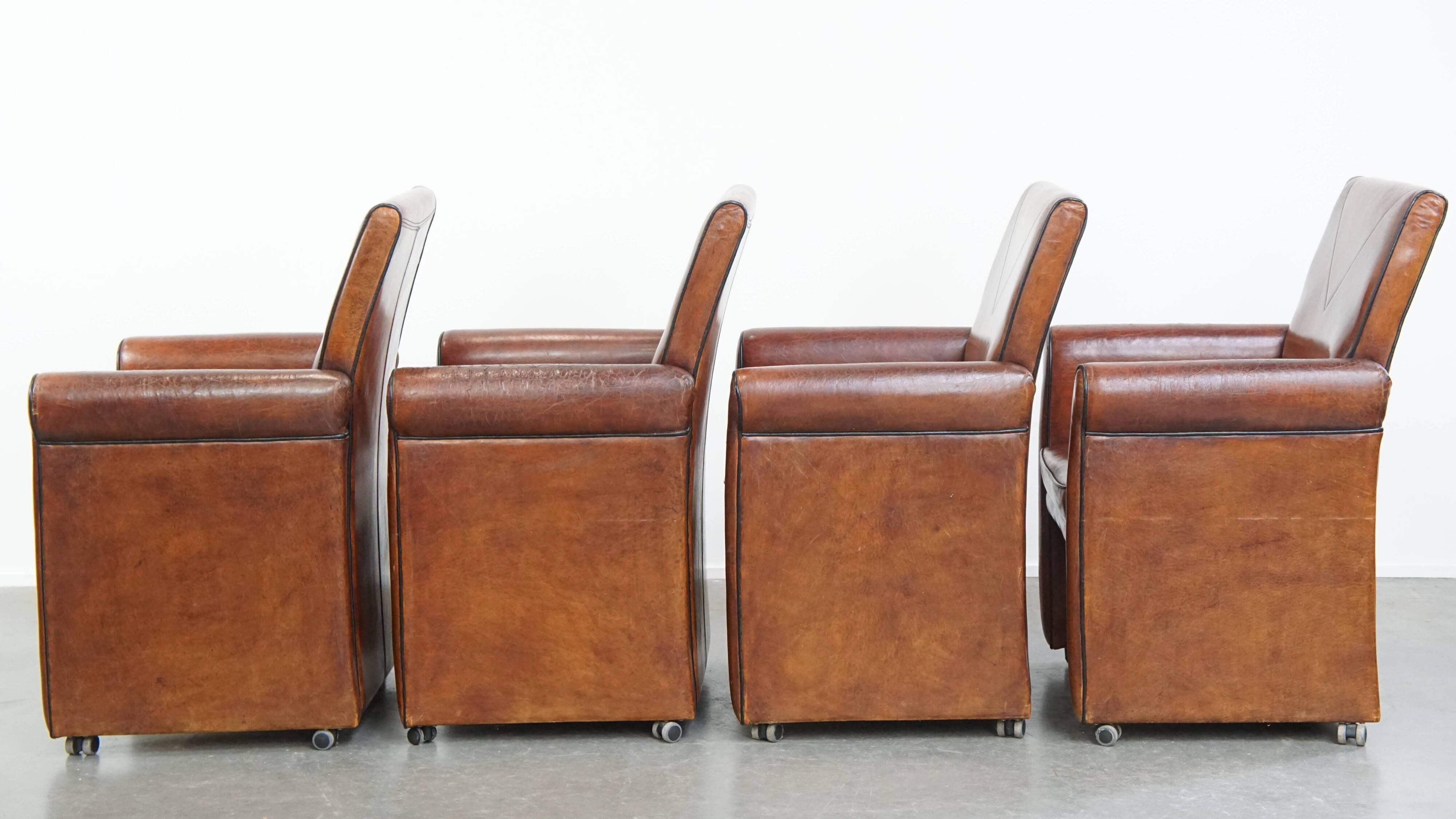 Vintage set of 4 sheepskin leather dining chairs on castors