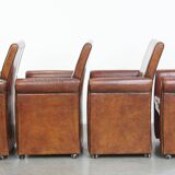 Vintage set of 4 sheepskin leather dining chairs on castors