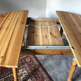 Round table in varnished pine with extension cord